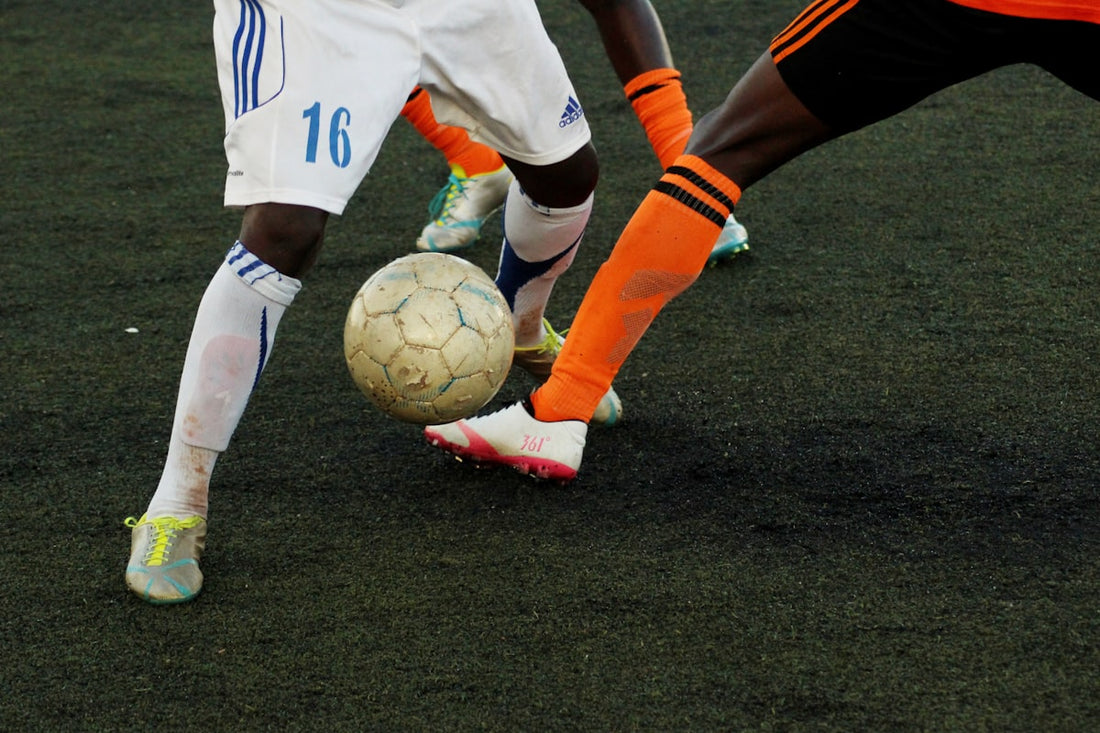 Youth soccer player training with cones on a field