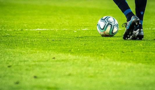 Soccer player controlling the ball in midfield